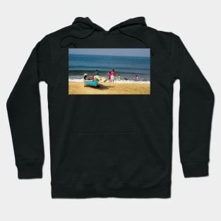 Families enjoy the time on the beach in India Hoodie